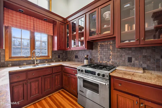 a kitchen with stainless steel appliances granite countertop a stove and a sink