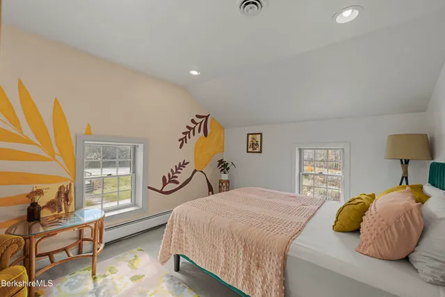 a bedroom with a bed and a couch