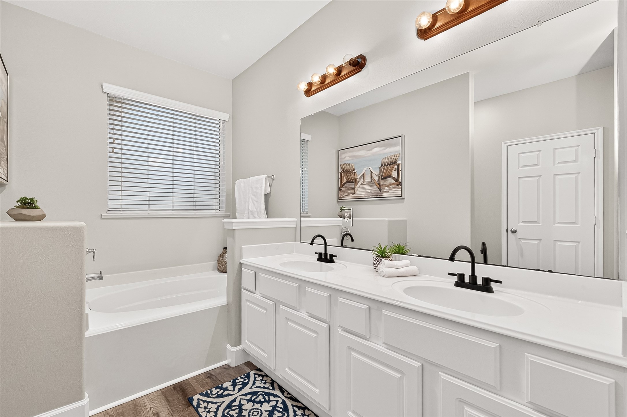 7415 Riven Oaks Court Cypress, TX 77433 - Photo 24 of 42 Spacious primary bath featuring double sinks, a relaxing soaking tub, and abundant natural light, along with a large walk-in closet offering ample storage and organization.