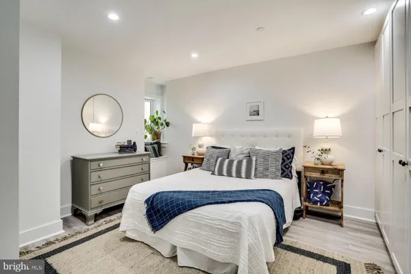 a bedroom with a bed and a dresser