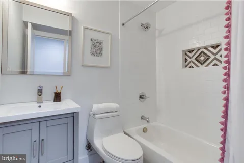 a white toilet sitting next to a bathroom sink