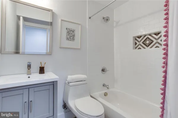 a white toilet sitting next to a bathroom sink