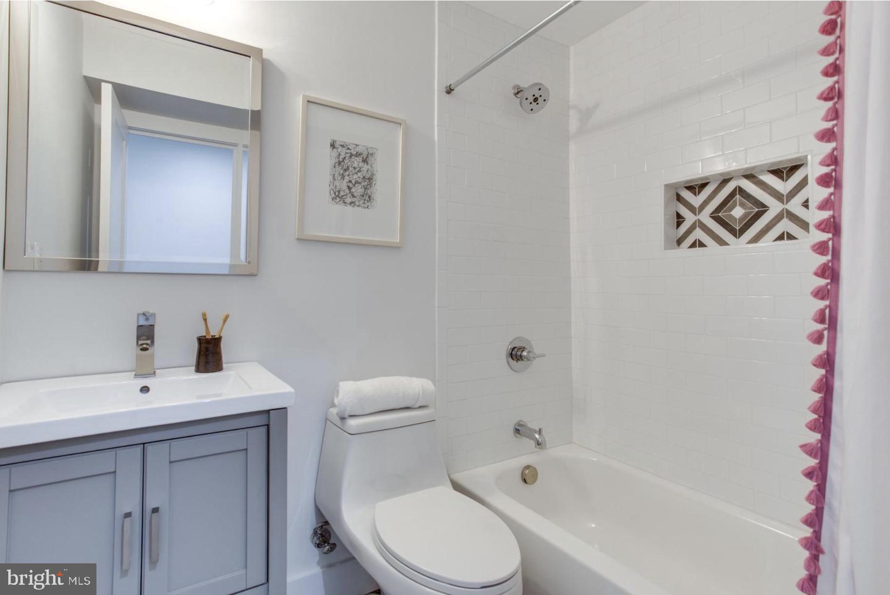 22 Bryant Street Northwest, Unit 1 Washington, DC 20001 - Photo 17 of 24 a white toilet sitting next to a bathroom sink