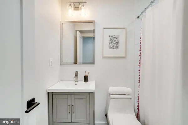 a bathroom with a toilet a sink and mirror