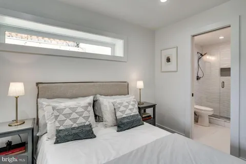 a bedroom with a bed and a night stand