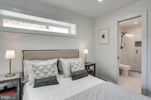 a bedroom with a bed and a night stand