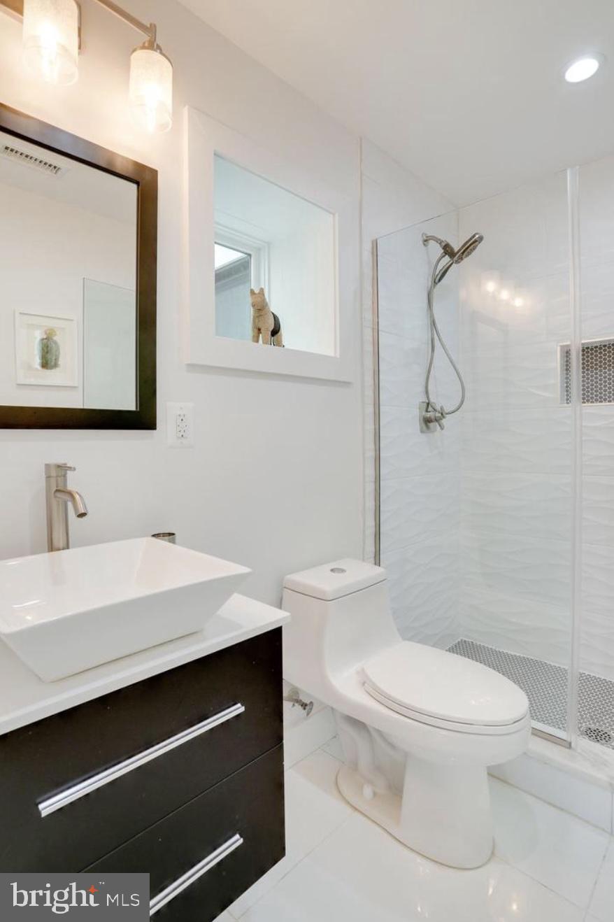 22 Bryant Street Northwest, Unit 1 Washington, DC 20001 - Photo 22 of 24 a bathroom with a sink a toilet and shower