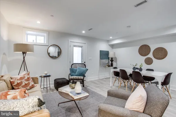 a living room with furniture and a mirror