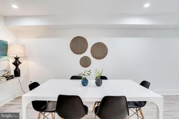 a dining room with furniture and a mirror