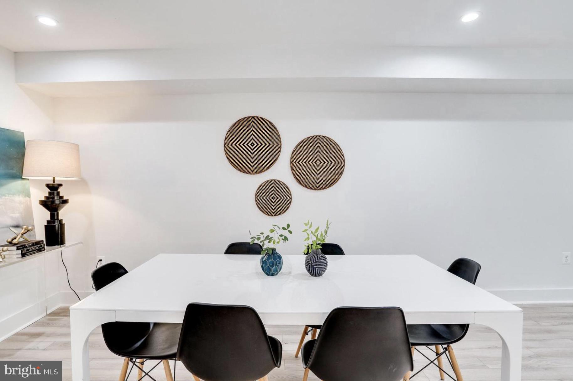 22 Bryant Street Northwest, Unit 1 Washington, DC 20001 - Photo 7 of 24 a dining room with furniture and a mirror