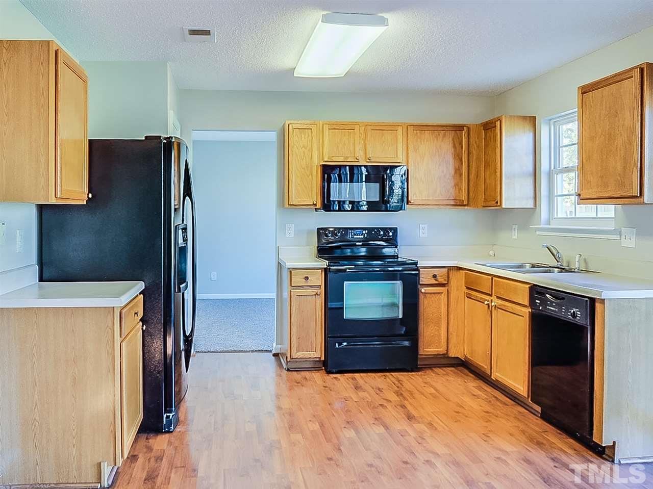 5705 Quitman Trail Raleigh, NC 27610 - Photo 2 of 20 a kitchen with stainless steel appliances a stove a refrigerator a sink a stove and cabinets