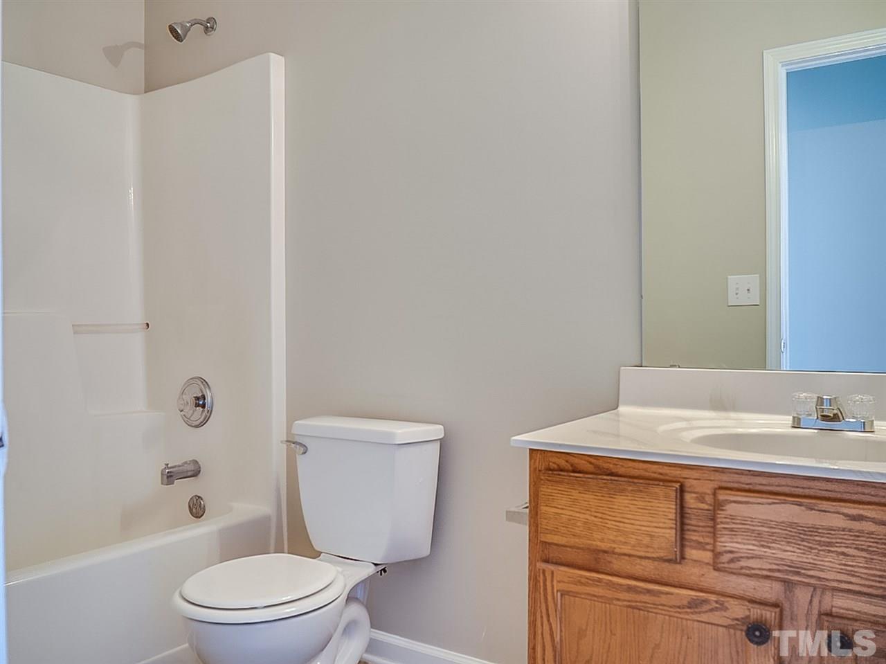 5705 Quitman Trail Raleigh, NC 27610 - Photo 17 of 20 a bathroom with a sink a toilet and shower