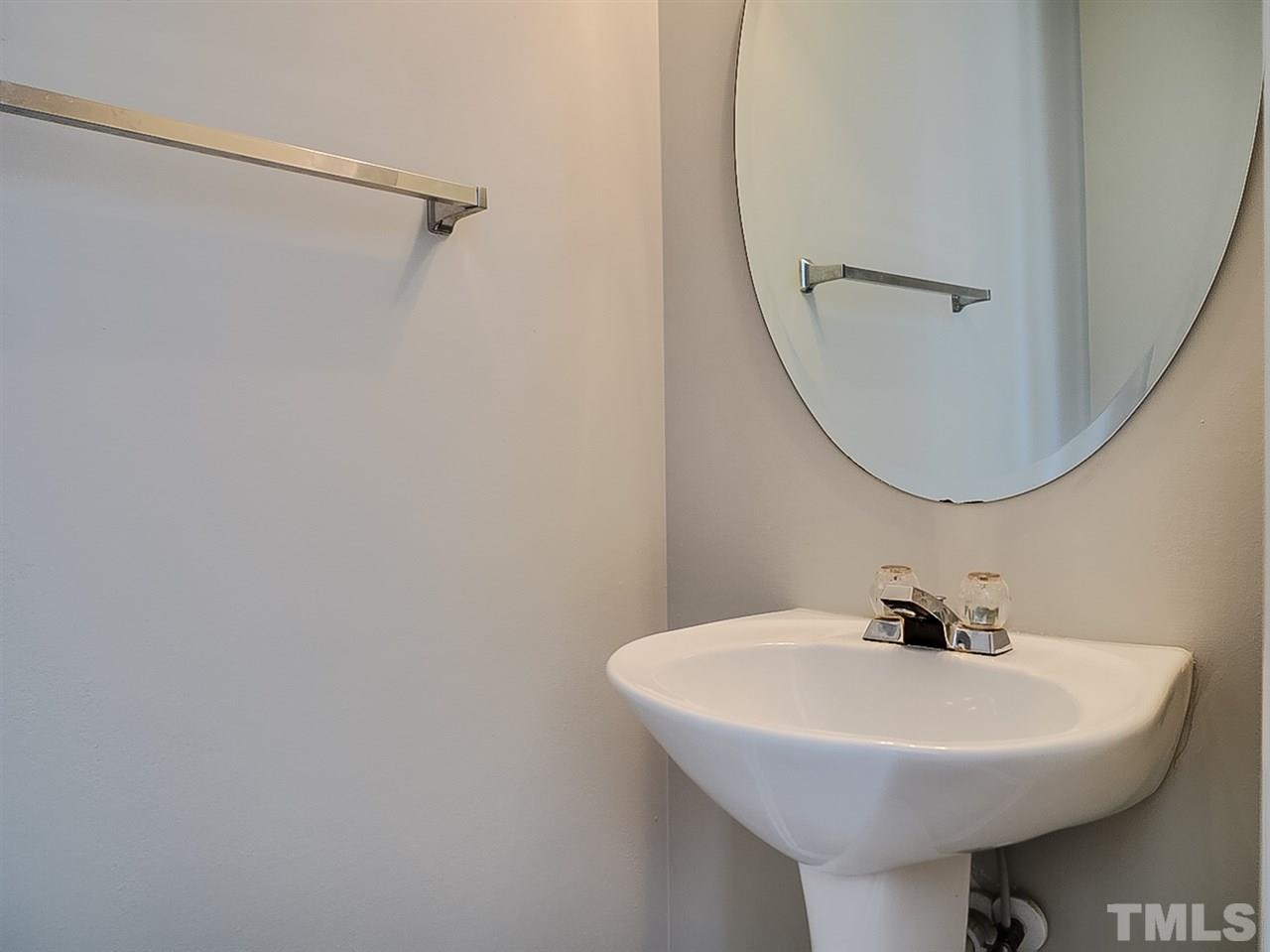 5705 Quitman Trail Raleigh, NC 27610 - Photo 18 of 20 a bathroom with a sink a mirror and a toilet