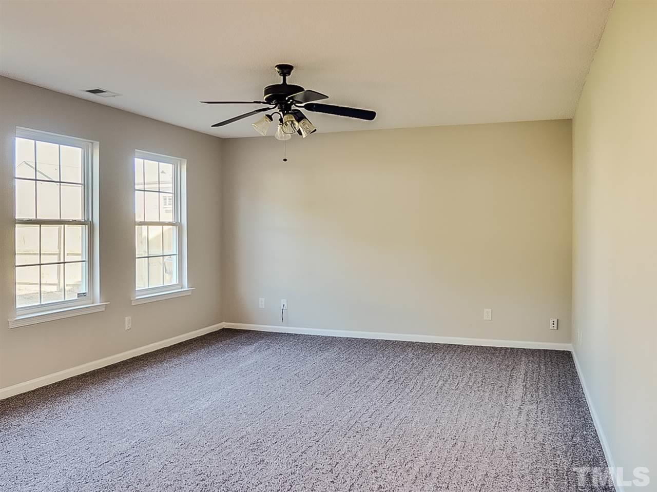 5705 Quitman Trail Raleigh, NC 27610 - Photo 4 of 20 an empty room with a window and a fan