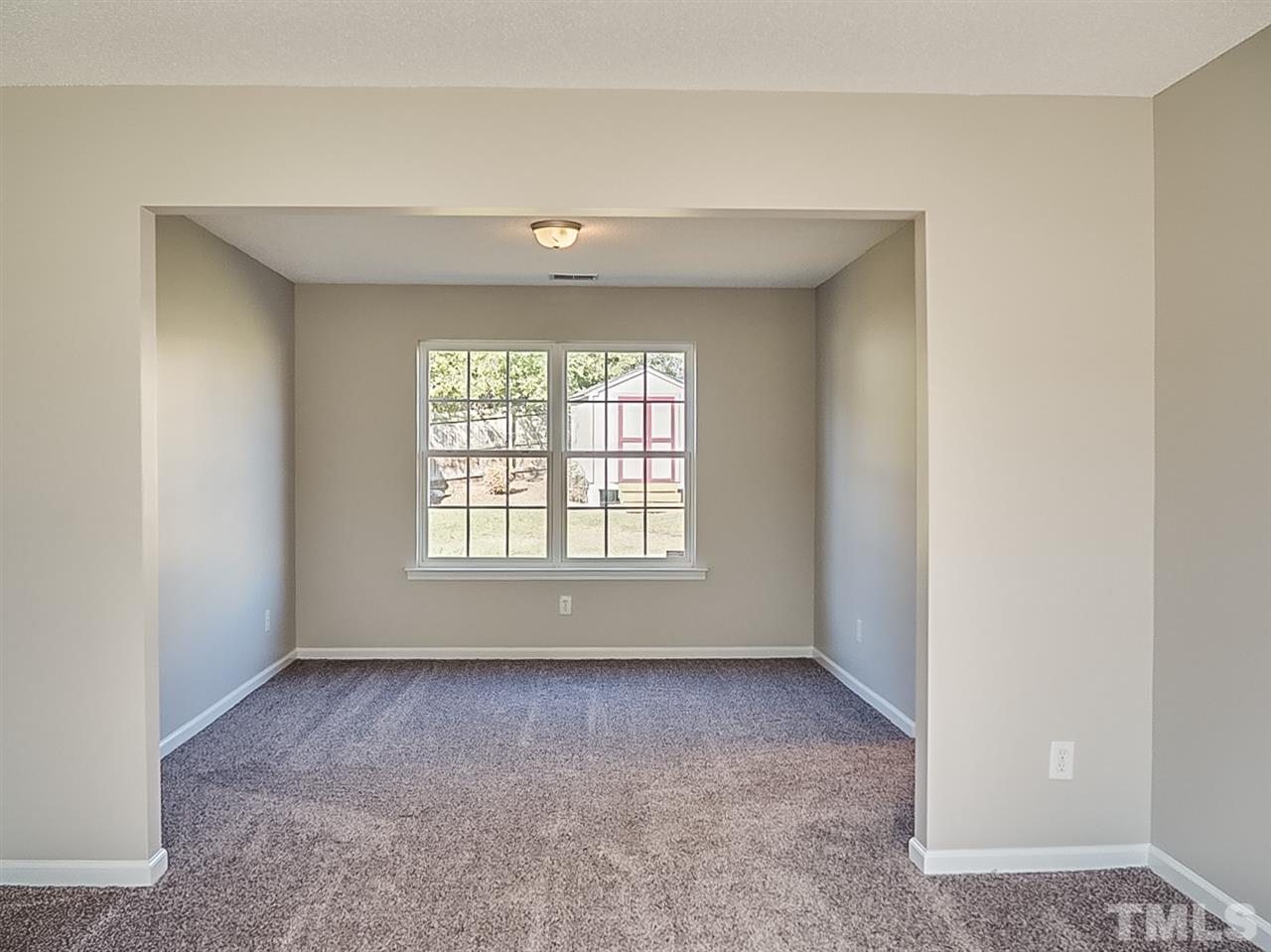 5705 Quitman Trail Raleigh, NC 27610 - Photo 5 of 20 a view of an empty room with a window