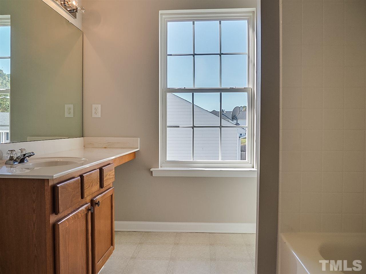 5705 Quitman Trail Raleigh, NC 27610 - Photo 10 of 20 a bathroom with a sink and a window