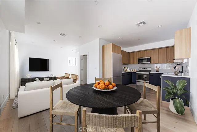 a view of a dining room with furniture and a kitchen