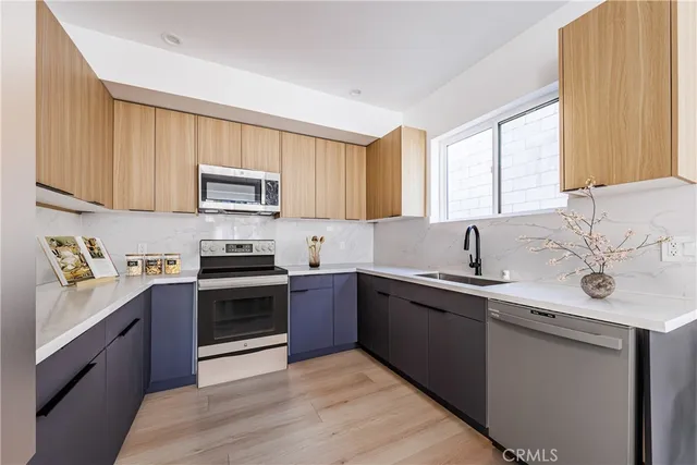 a kitchen with stainless steel appliances granite countertop a sink and stove top oven