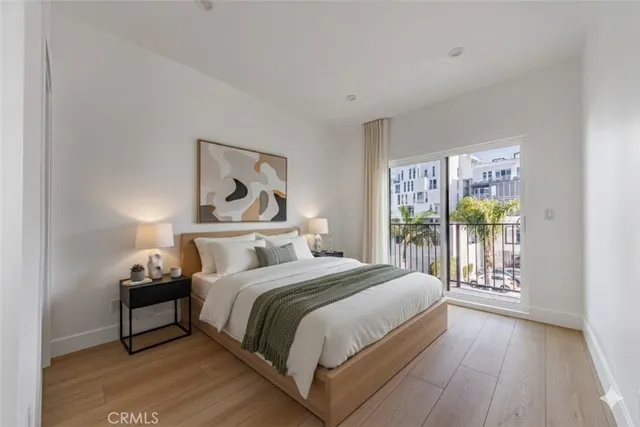 a bedroom with a bed and a painting on the wall