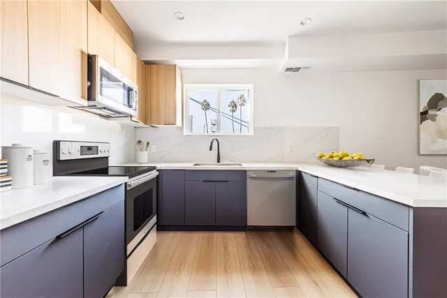 a kitchen with a sink stove and cabinets