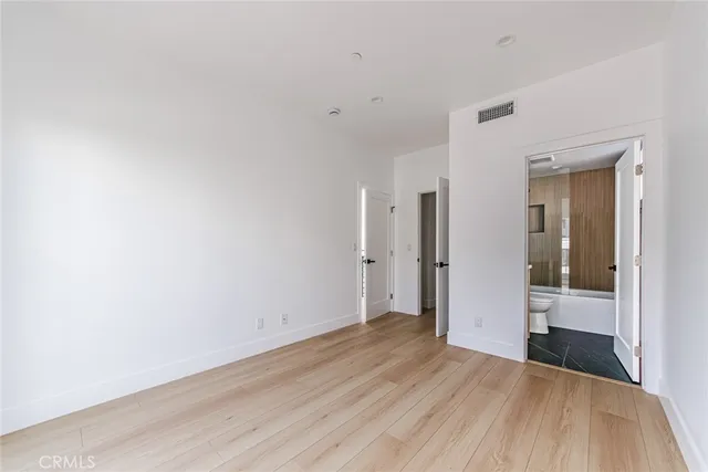 a view of a room with wooden floor and brick walls