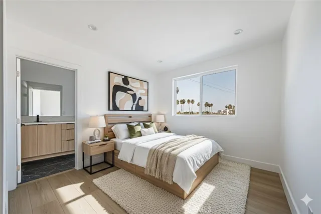 a bedroom with a bed and a painting on the wall