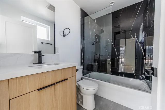 a bathroom with a sink a toilet and a bathtub