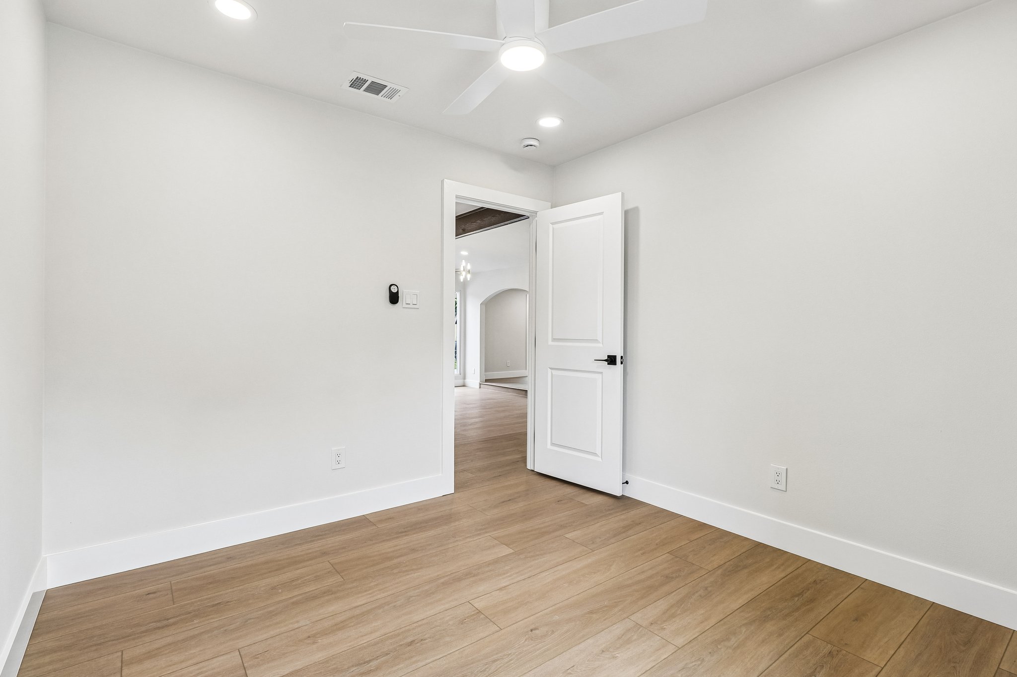 11809 Charing Cross Road Austin, TX 78759 - Photo 20 of 34 A quiet secondary room offers plank flooring and recessed lighting, ready for personalized use.