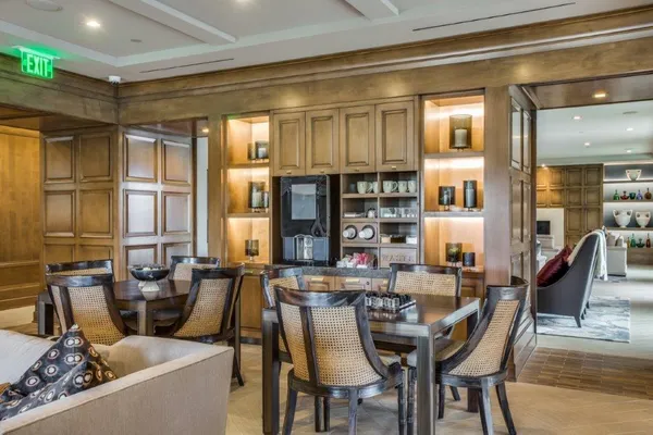 a living room with furniture and large windows