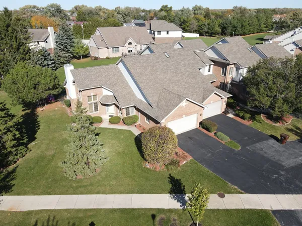 an aerial view of a house with a yard