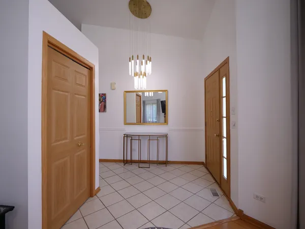 an empty room with windows and cabinet