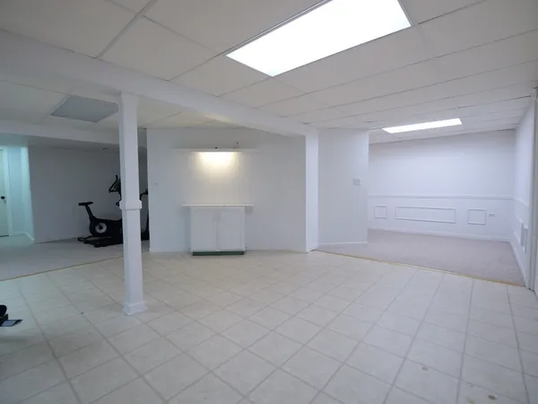 a bedroom with a bed and a computer on the desk