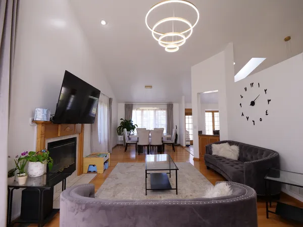 a living room with fireplace furniture and a flat screen tv