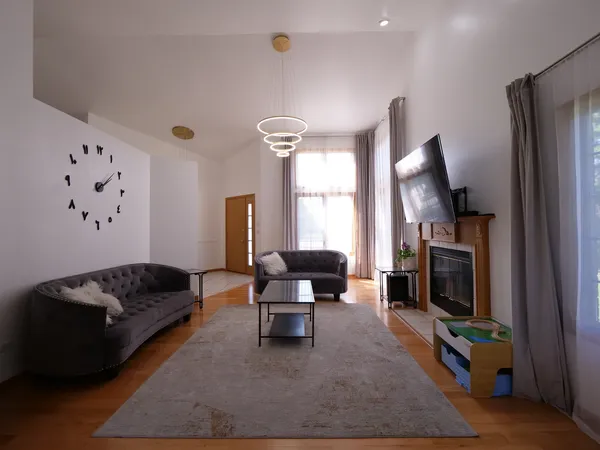 a living room with furniture window and a flat screen tv