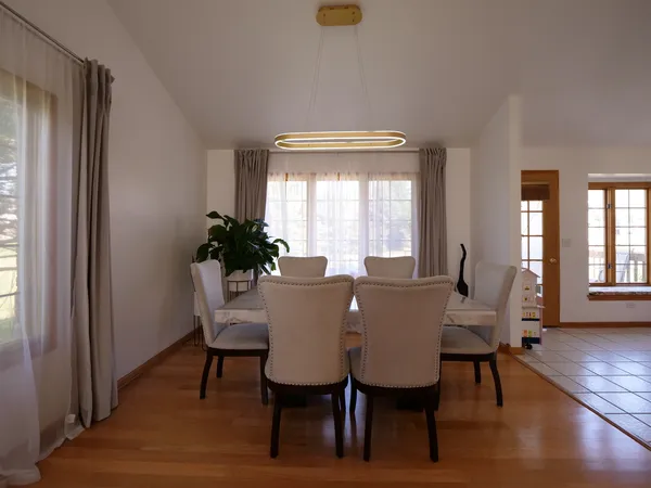 a view of a dining room with furniture and wooden floor