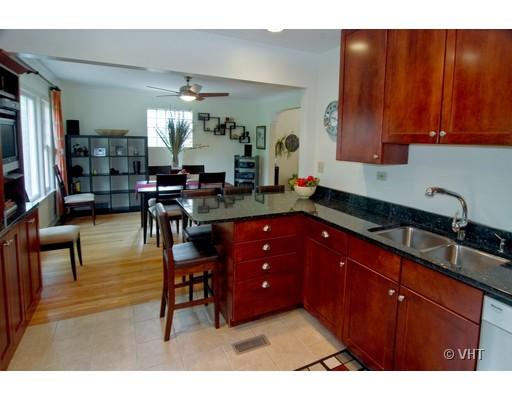 470 Uvedale Road Riverside, IL 60546 - Photo 4 of 12 a kitchen with granite countertop a sink dishwasher a stove and cabinets with wooden floor