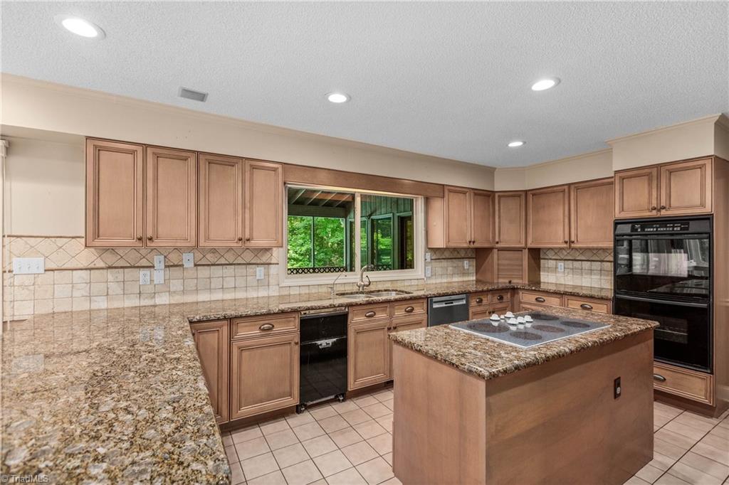 4200 Clinard Road Clemmons, NC 27012 - Photo 15 of 49 Kitchen with island, window over looking huge screened in porch with a serving bar at window.