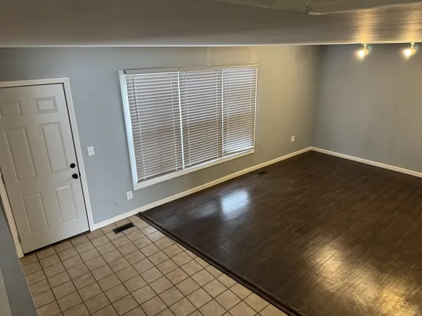 an empty room with wooden floor