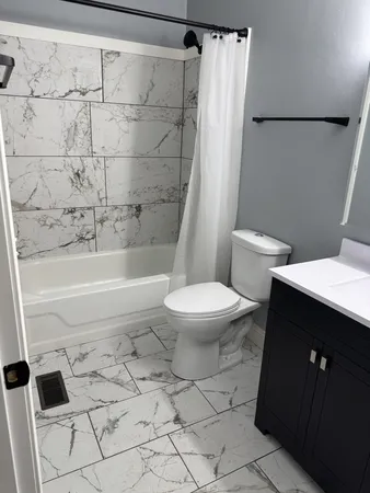 a bathroom with a toilet and a shower