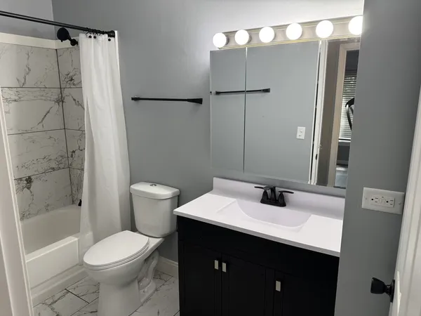a bathroom with a sink toilet and shower