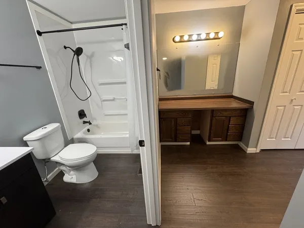 a bathroom with a toilet a sink and shower