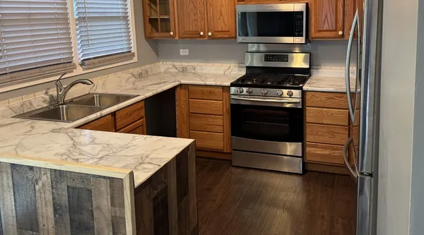 a kitchen with a sink stove and microwave