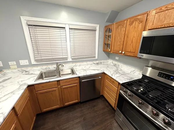 a kitchen with a sink stove top oven and cabinets