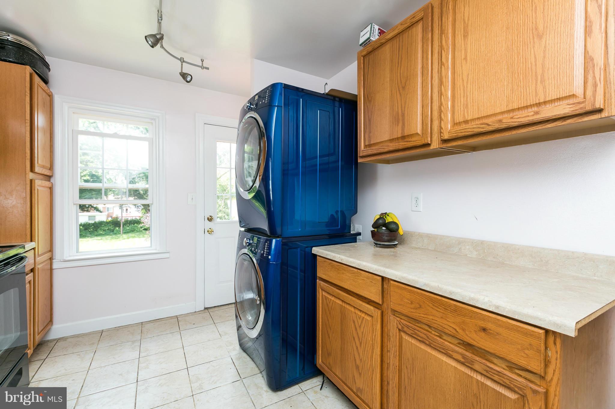 12712 Flack Street Silver Spring, MD 20906 - Photo 11 of 28 a kitchen with stainless steel appliances granite countertop wooden cabinets a sink and a window