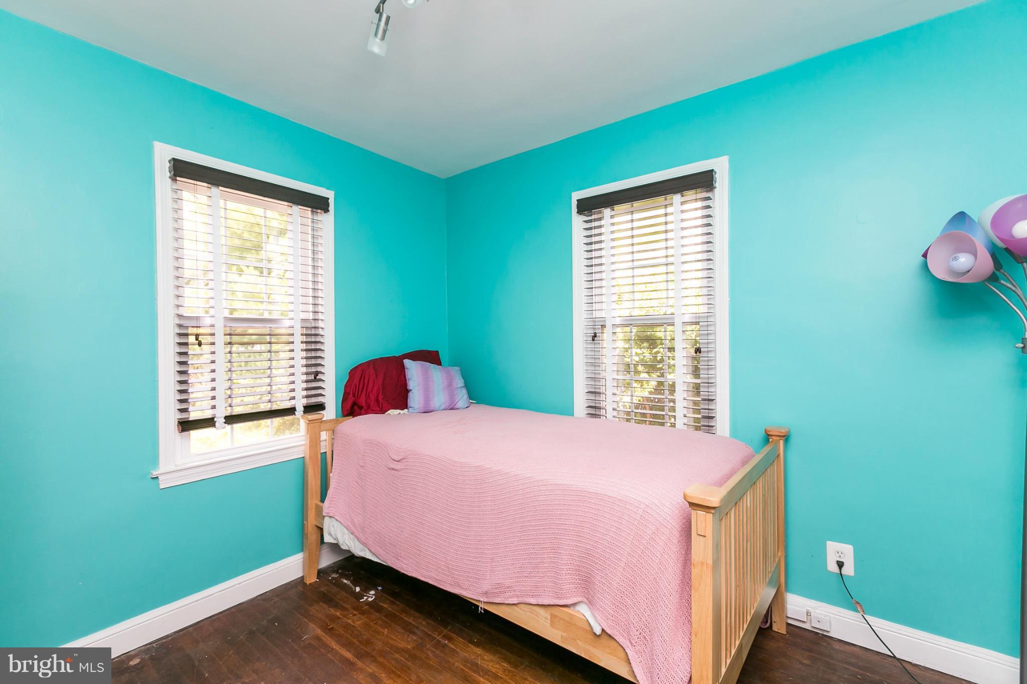 12712 Flack Street Silver Spring, MD 20906 - Photo 12 of 28 a bedroom with a bed and windows