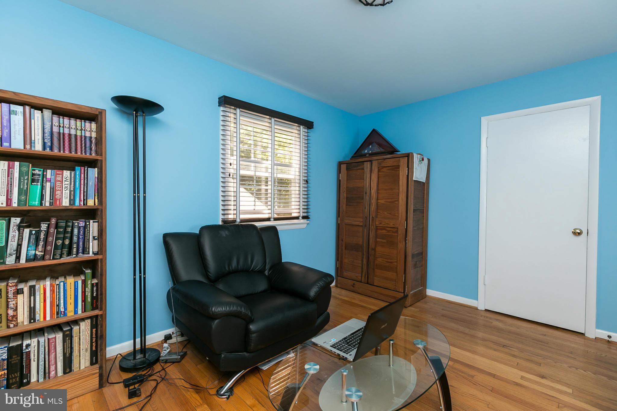 12712 Flack Street Silver Spring, MD 20906 - Photo 16 of 28 a living room with furniture and a book shelf