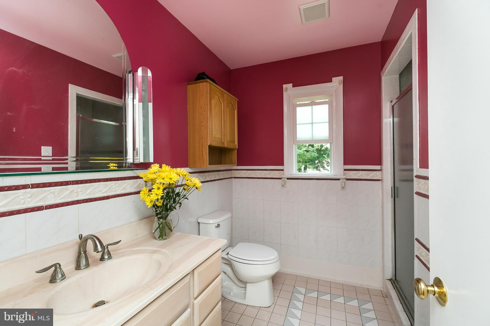 12712 Flack Street Silver Spring, MD 20906 - Photo 17 of 28 a bathroom with a toilet sink and mirror