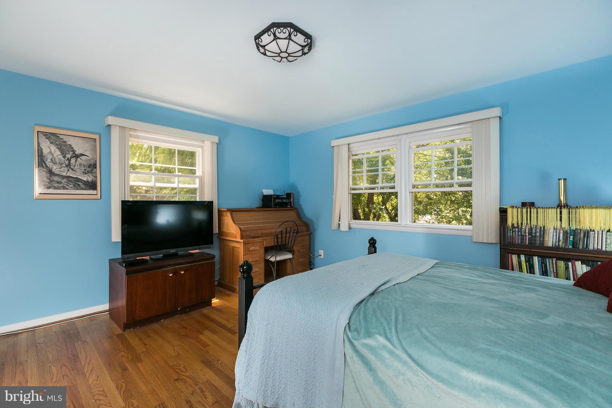 12712 Flack Street Silver Spring, MD 20906 - Photo 19 of 28 a bedroom with a bed and a flat screen tv