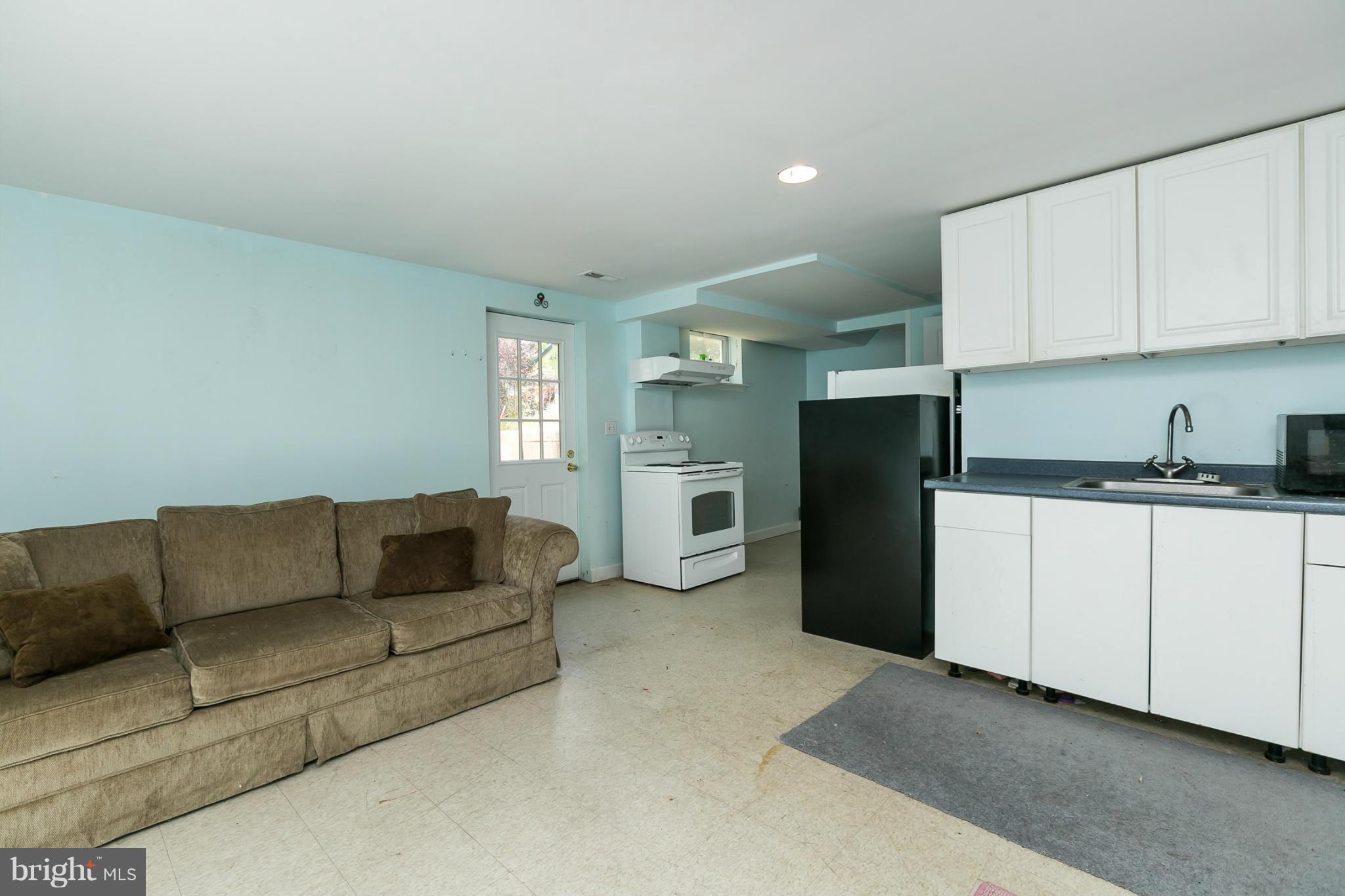 12712 Flack Street Silver Spring, MD 20906 - Photo 20 of 28 a living room with furniture and a refrigerator