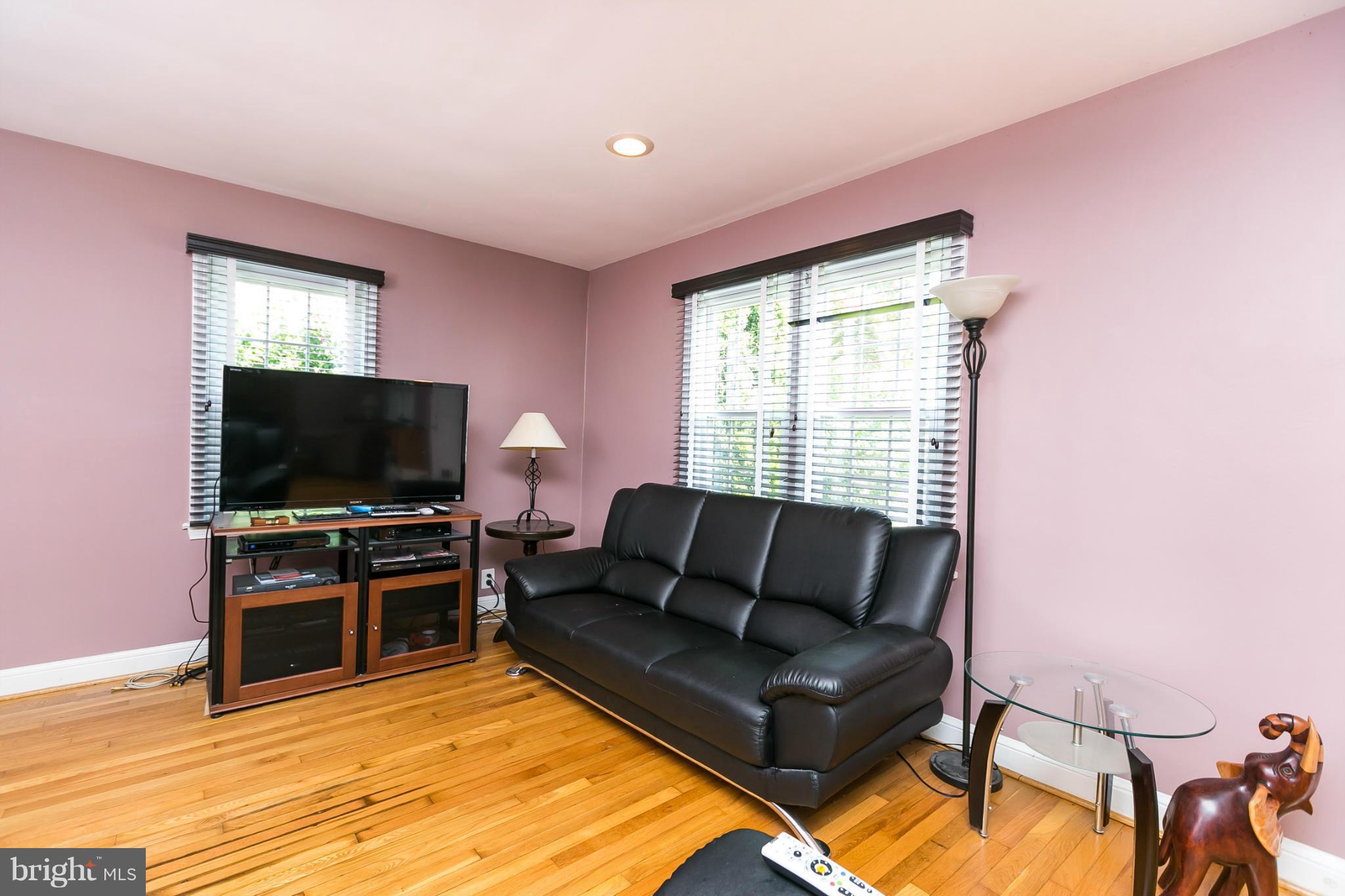 12712 Flack Street Silver Spring, MD 20906 - Photo 3 of 28 a living room with furniture and a flat screen tv